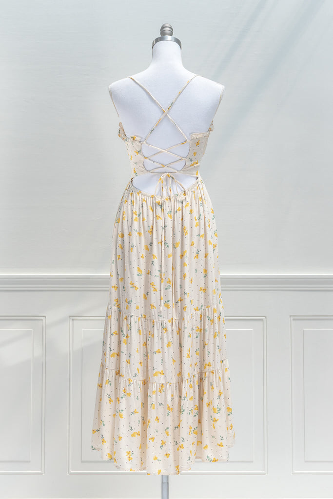 french dresses in vintage and cottage core style - a midi dress in cream and small flower print, drawstring neckline and spaghetti straps - back view 