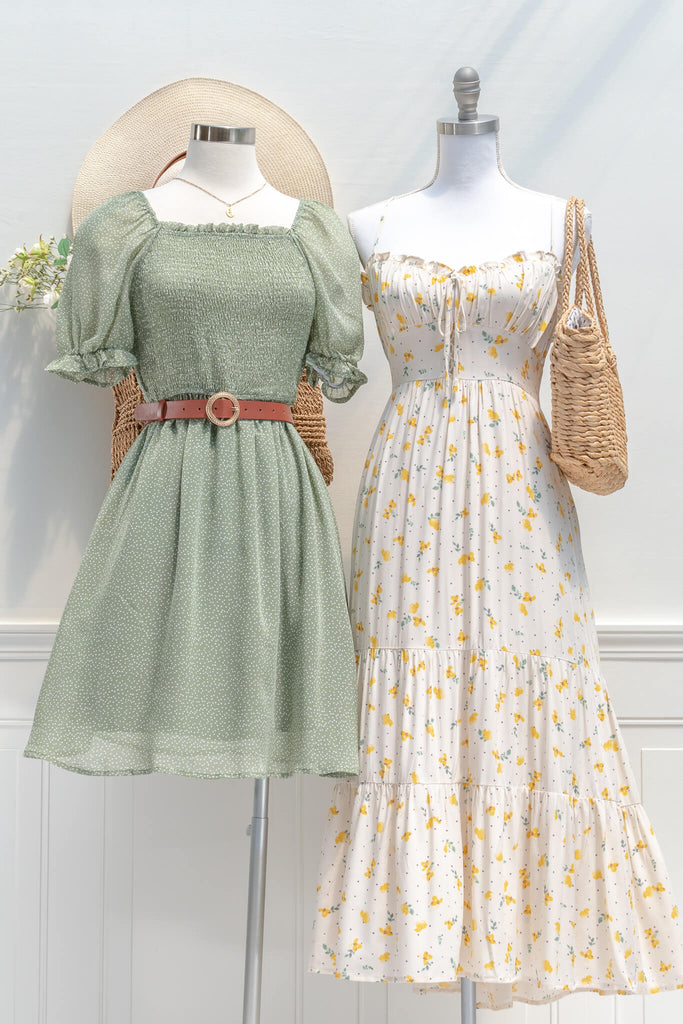 french dresses in vintage and cottage core style - a midi dress in cream and small flower print, drawstring neckline and spaghetti straps - next to green dress view 