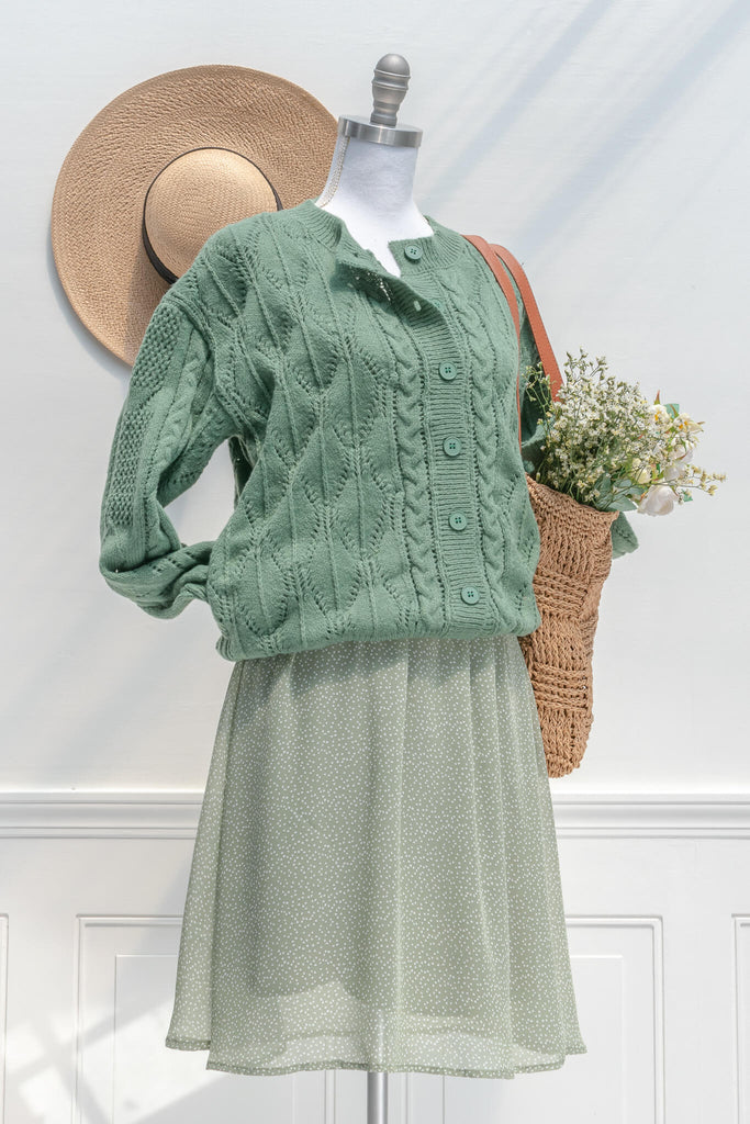 cottage core dresses in french and vintage style - this is a mini dress with a square neckline, chiffon fabric, and sage small heart print - amantine - styled with cardigan view - 
