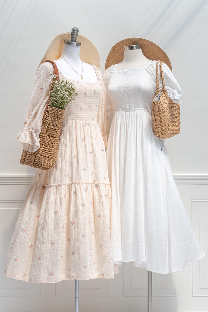 french dress - a feminine aesthetic dress in cream, with long sleeves, ruched midriff, square neckline, ruffle sleeves, and small floral print. Cream color base. Amantine - next to another feminine dress view