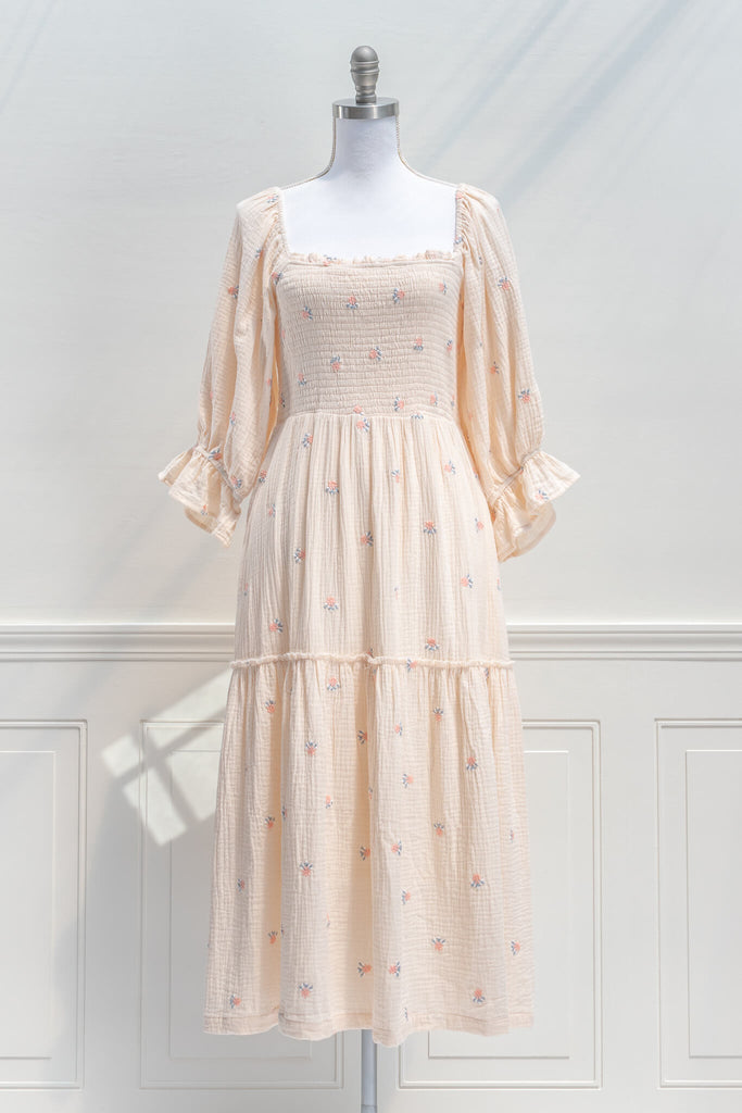 french dress - a feminine aesthetic dress in cream, with long sleeves, ruched midriff, square neckline, ruffle sleeves, and small floral print. Cream color base. Amantine - Front view