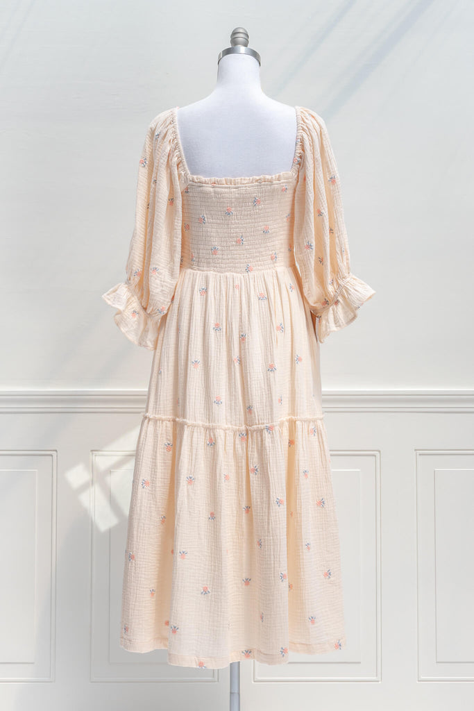 french dress - a feminine aesthetic dress in cream, with long sleeves, ruched midriff, square neckline, ruffle sleeves, and small floral print. Cream color base. Amantine - back view