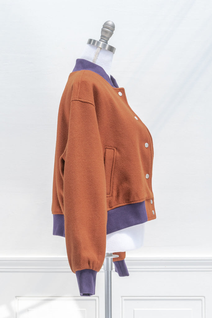 french girl style clothing - an autumn aesthetic varsity jacket in rust orange and purple details - side view 
