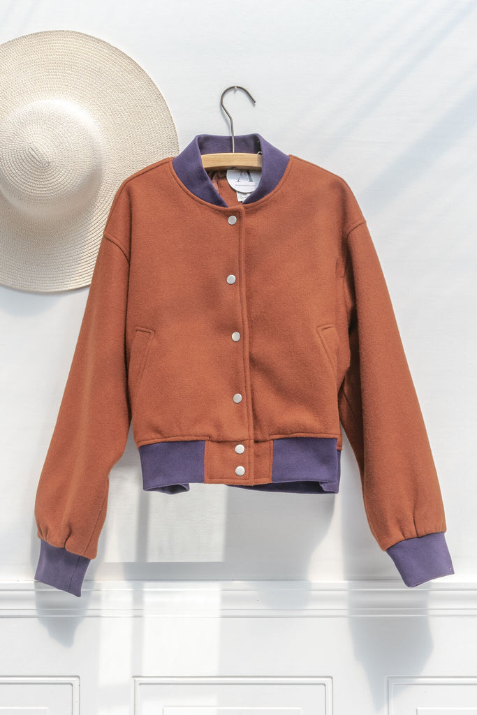 french girl style clothing - an autumn aesthetic varsity jacket in rust orange and purple details - front view 