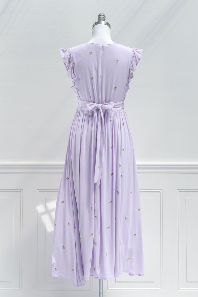 French Dress / A feminine floral embroidered dress with a v neckline and flutter sleeves in purple. back view