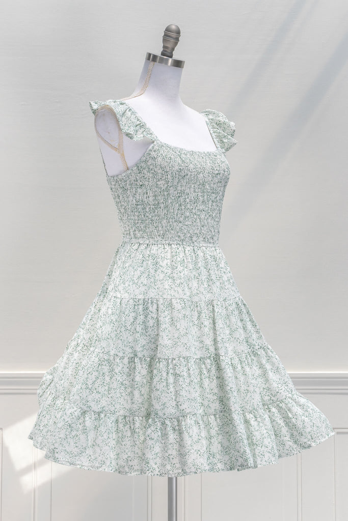 aesthetic dresses - french and vintage style mini dress from amantine - features a square neckline, ruched midriff, pockets, and a light green floral print - quarter view 