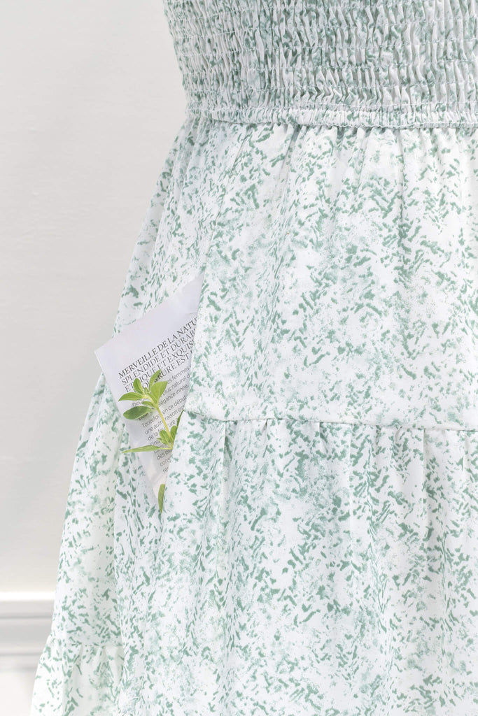 aesthetic dresses - french and vintage style mini dress from amantine - features a square neckline, ruched midriff, pockets, and a light green floral print - pocket up close view 