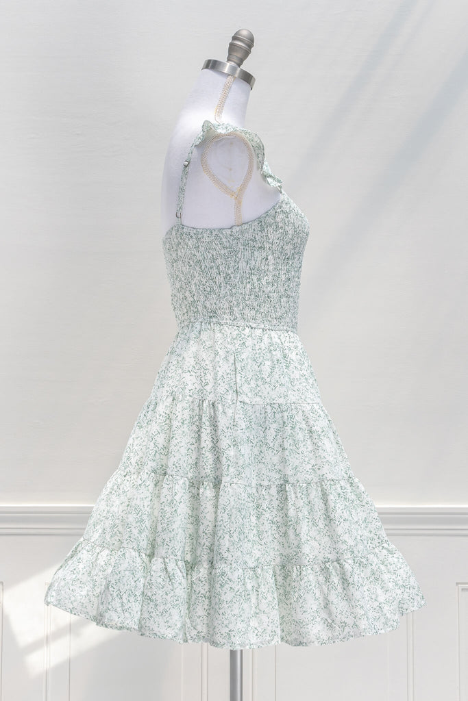 aesthetic dresses - french and vintage style mini dress from amantine - features a square neckline, ruched midriff, pockets, and a light green floral print - side view 