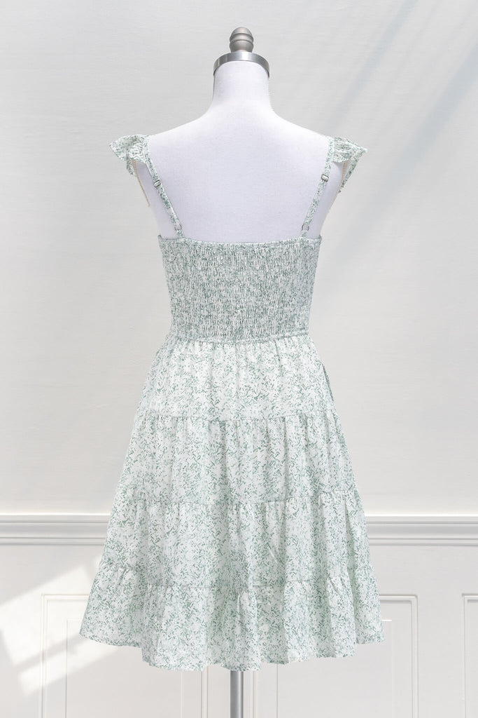 aesthetic dresses - french and vintage style mini dress from amantine - features a square neckline, ruched midriff, pockets, and a light green floral print - back view 