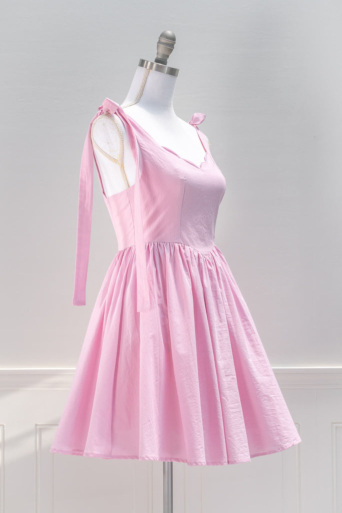 pink aesthetic dresses from amantine - a pink barbiecore mini dress, sweetheart neckline and tie shoulder straps - quarter view 