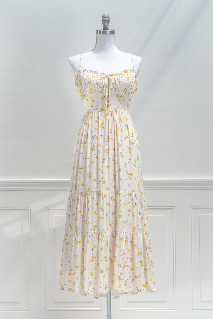french dresses in vintage and cottage core style - a midi dress in cream and small flower print, drawstring neckline and spaghetti straps - front view 
