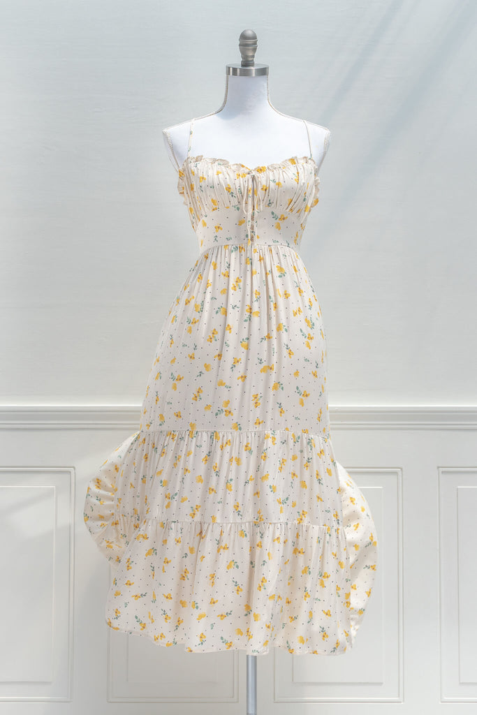 french dresses in vintage and cottage core style - a midi dress in cream and small flower print, drawstring neckline and spaghetti straps - view 