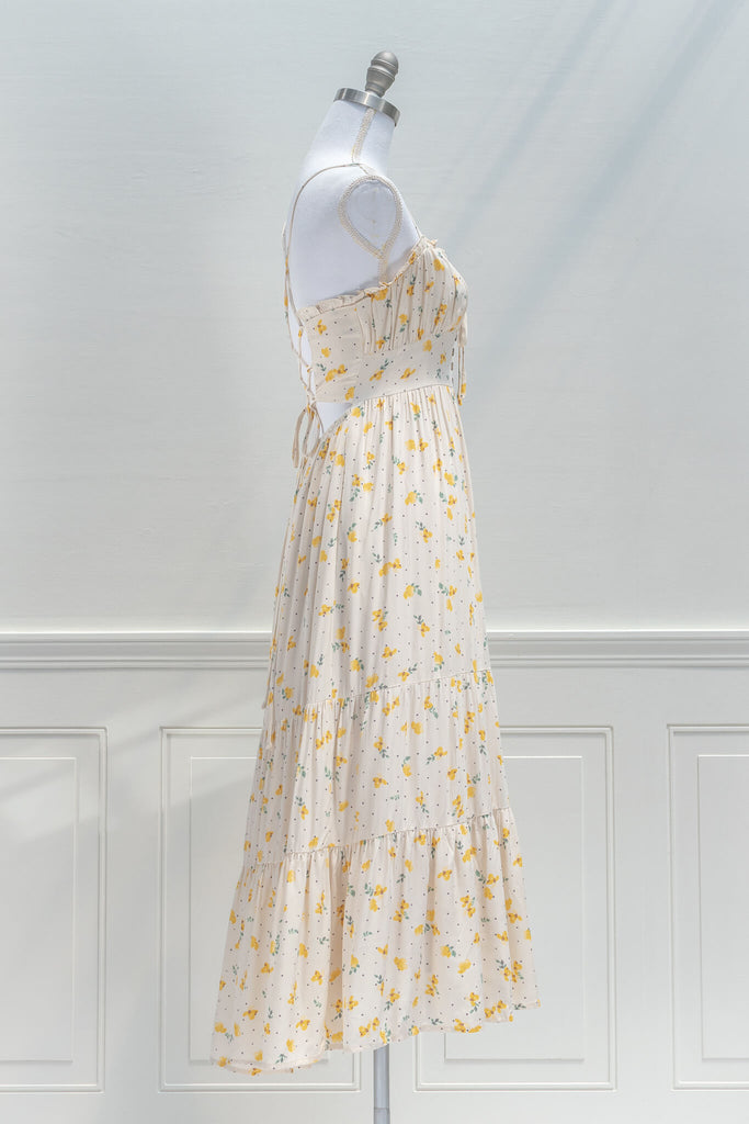 french dresses in vintage and cottage core style - a midi dress in cream and small flower print, drawstring neckline and spaghetti straps - side view 