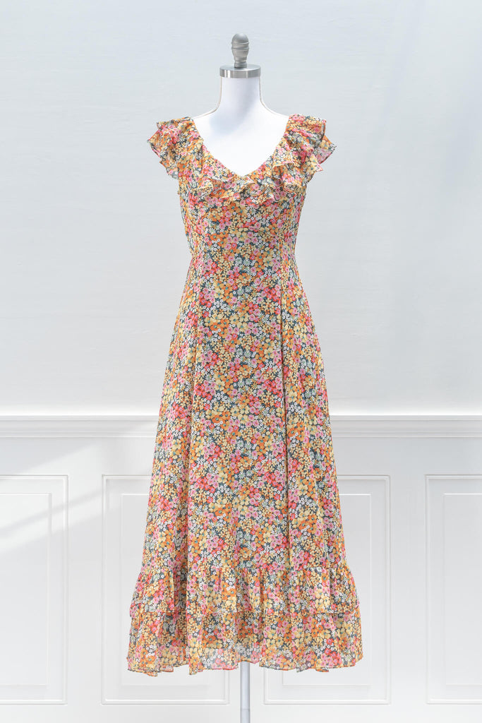 aesthetic dresses - french style -a bright floral print chiffon featuring a v-neckline, flutter shoulders, in an a line silhouette midi length - front view  