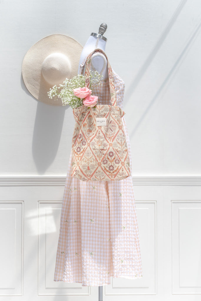 Floral dress on a mannequin with flowers against a white wall