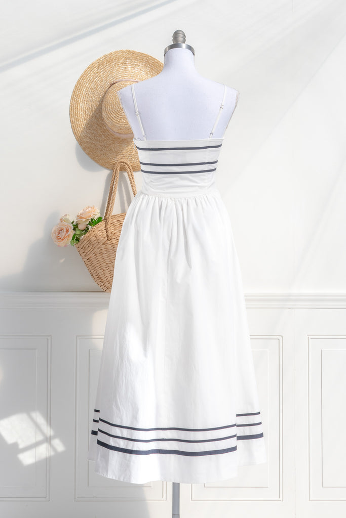 Back view of Amantine’s white and navy striped dress, highlighting the elegant stripe detail and a concealed zipper, perfect for a refined cottagecore style.