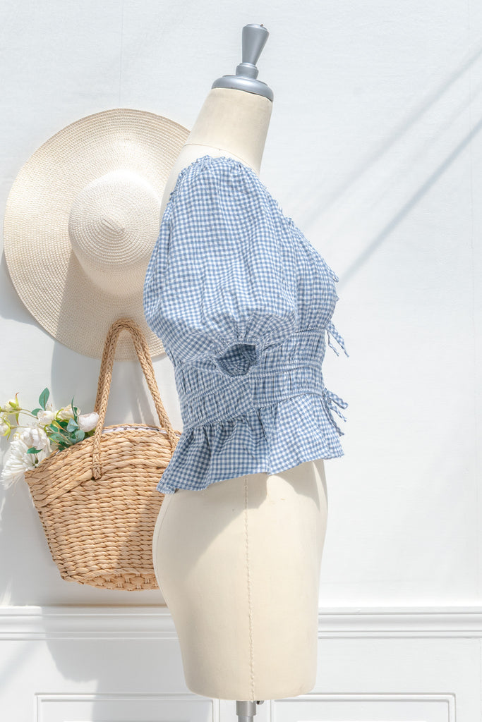 feminine clothing - a white and blue gingham peplum top with a sweetheart neckline and puff sleeves. perfect for summer activities or to feel romantic. side 2  view. amantine.
