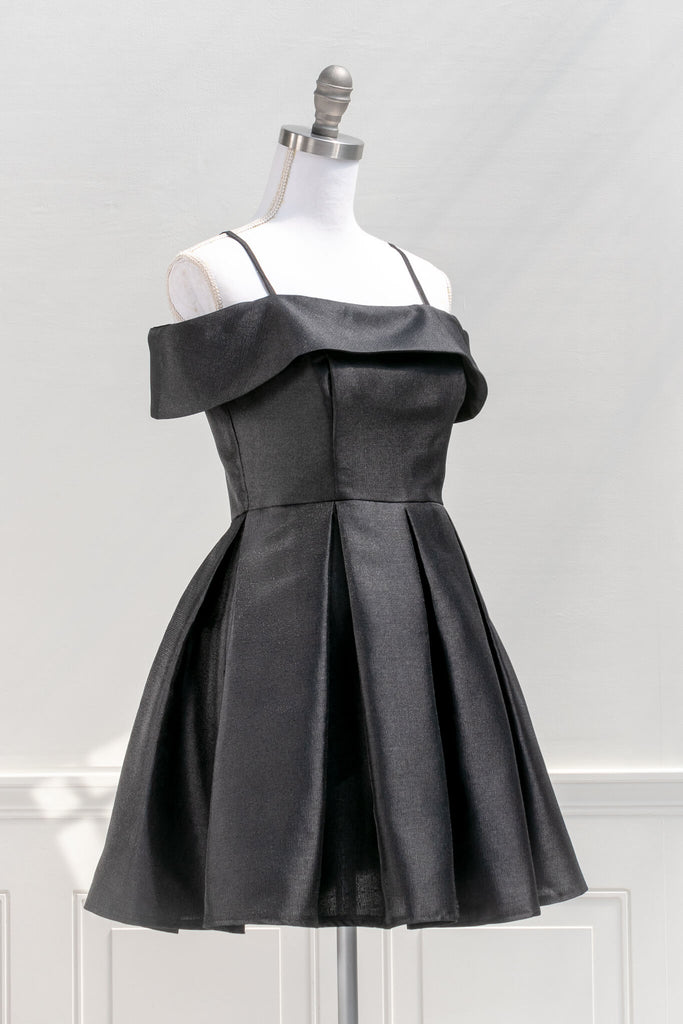 romantic dresses inspired by french, vintage, and feminine style - a beautiful mini cocktail dress in black, lbd, with box pleat skirt and off the shoulder neckline - amantine french dresses- quarter view 