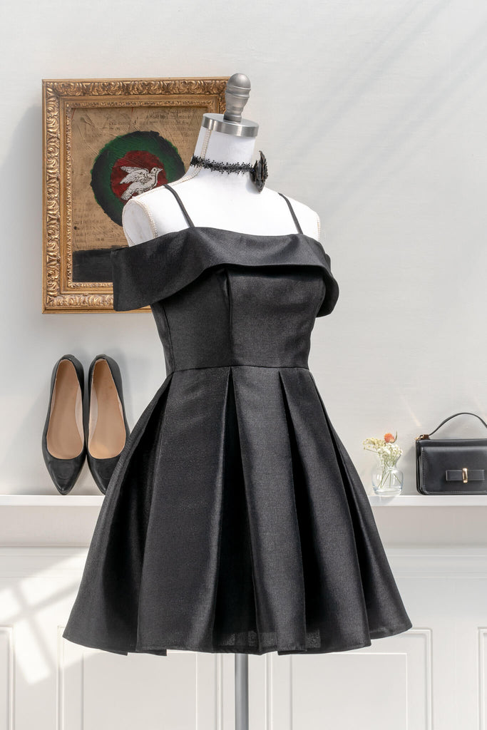 romantic dresses inspired by french, vintage, and feminine style - a beautiful mini cocktail dress in black, lbd, with box pleat skirt and off the shoulder neckline - amantine french dresses- styled view 