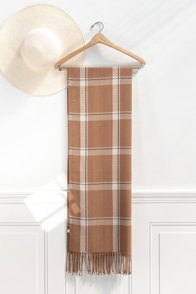 Feminine, french style scarf -simple-yet-chic scarf in a light brown and white plaid - on hanger view 