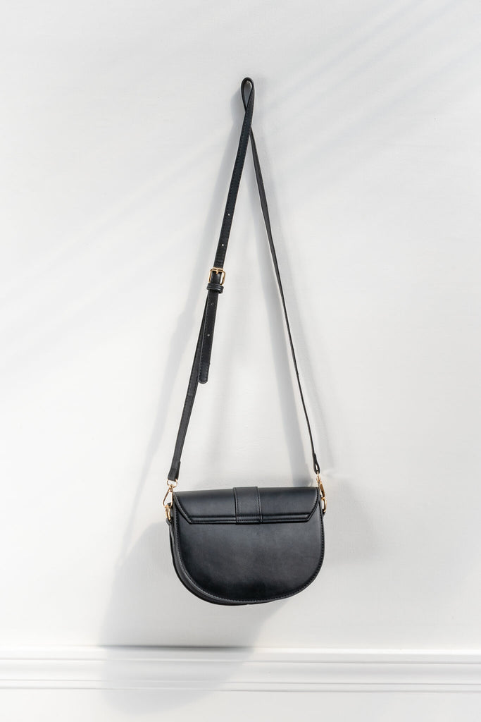 french style crossbody bag in black faux leather and gold buckle - back view 