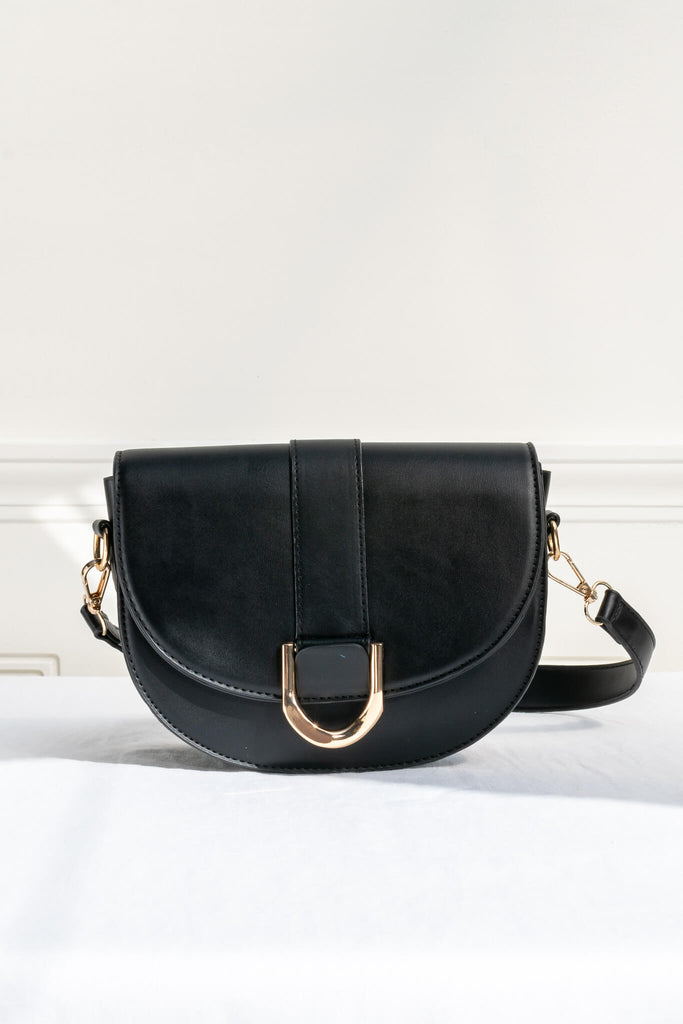 french style crossbody bag in black faux leather and gold buckle - front view 