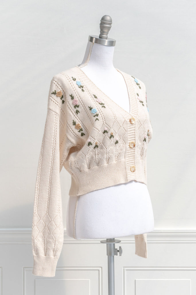 quarter side view of feminine french inspired cardigan - amantine. 