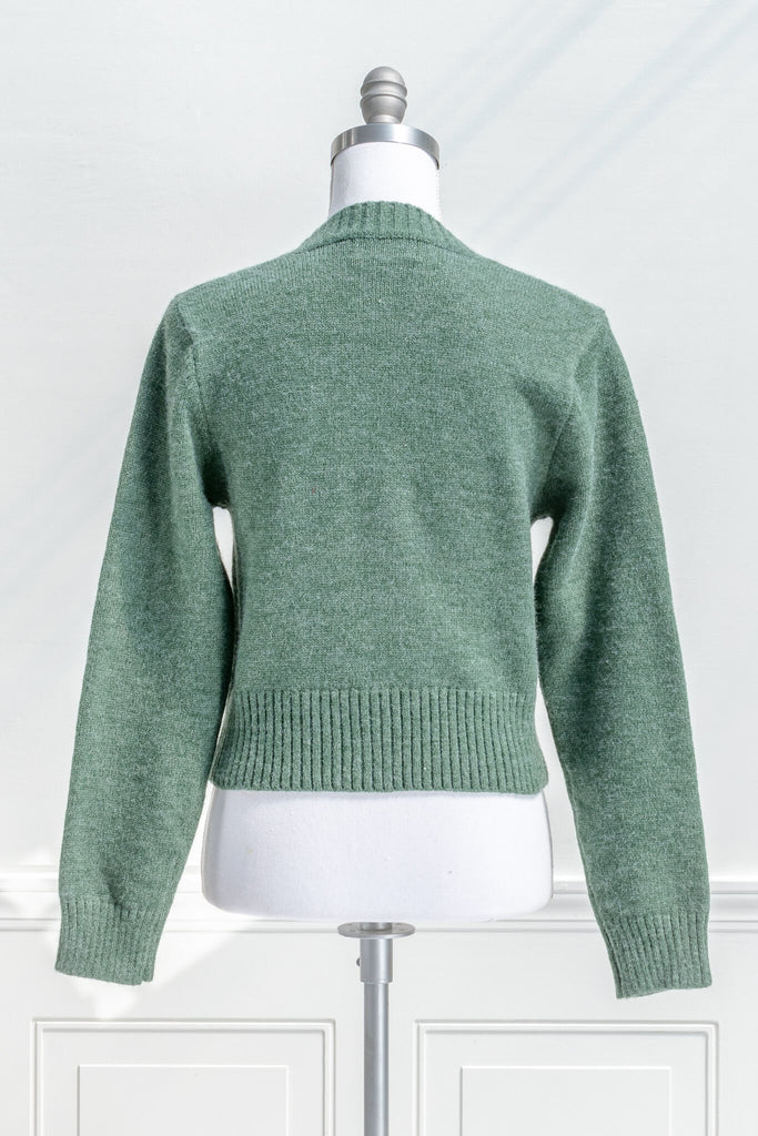 cottage core sweaters for autumn - a green wooly cardigan with floral motives cottagecore style- back view 