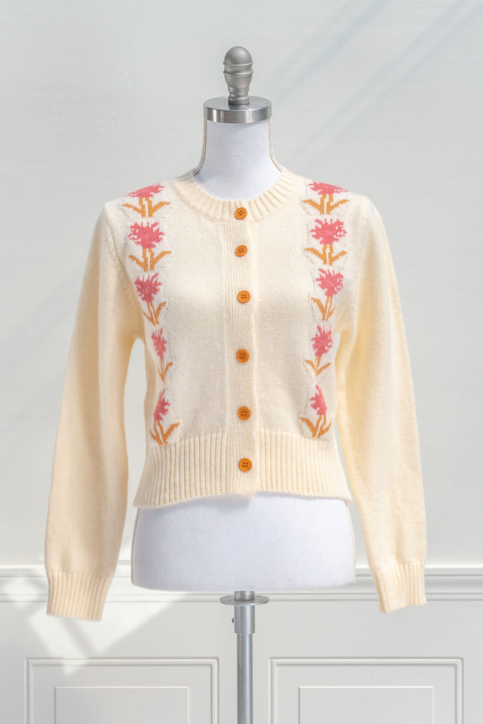 cottage core sweaters for autumn - a cream wooly cardigan with floral motives cottagecore style- front view 
