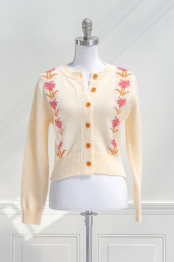cottage core sweaters for autumn - a cream wooly cardigan with floral motives cottagecore style- open buttons view 