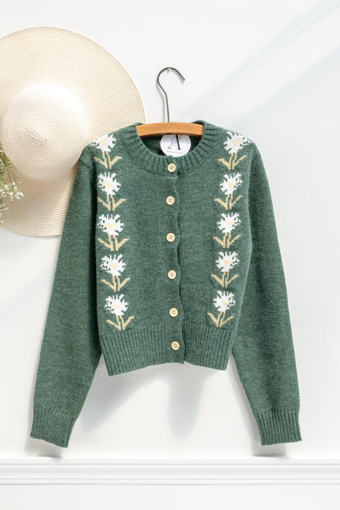 cottage core sweaters for autumn - a green wooly cardigan with floral motives cottagecore style- on hanger view 