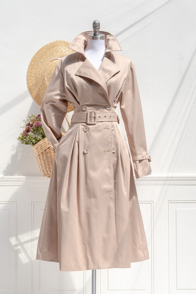 Front view of french girl trench coat with raised collar. feminine and sharp outfit. 