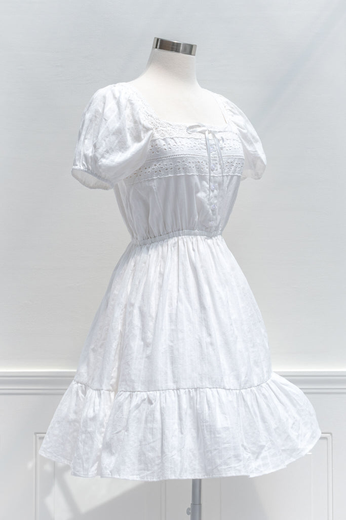 cottagecore dresses - a white eyelette cottagecore style square neckline and short sleeve mini dress - amantine - quarter view 