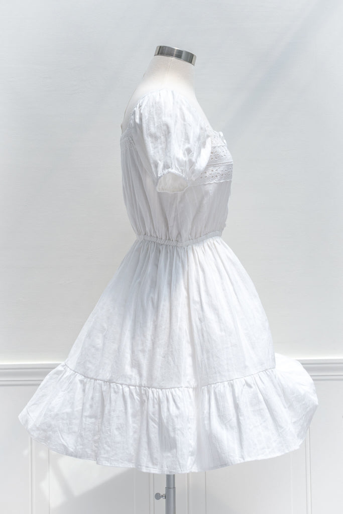 cottagecore dresses - a white eyelette cottagecore style square neckline and short sleeve mini dress - amantine - side view 