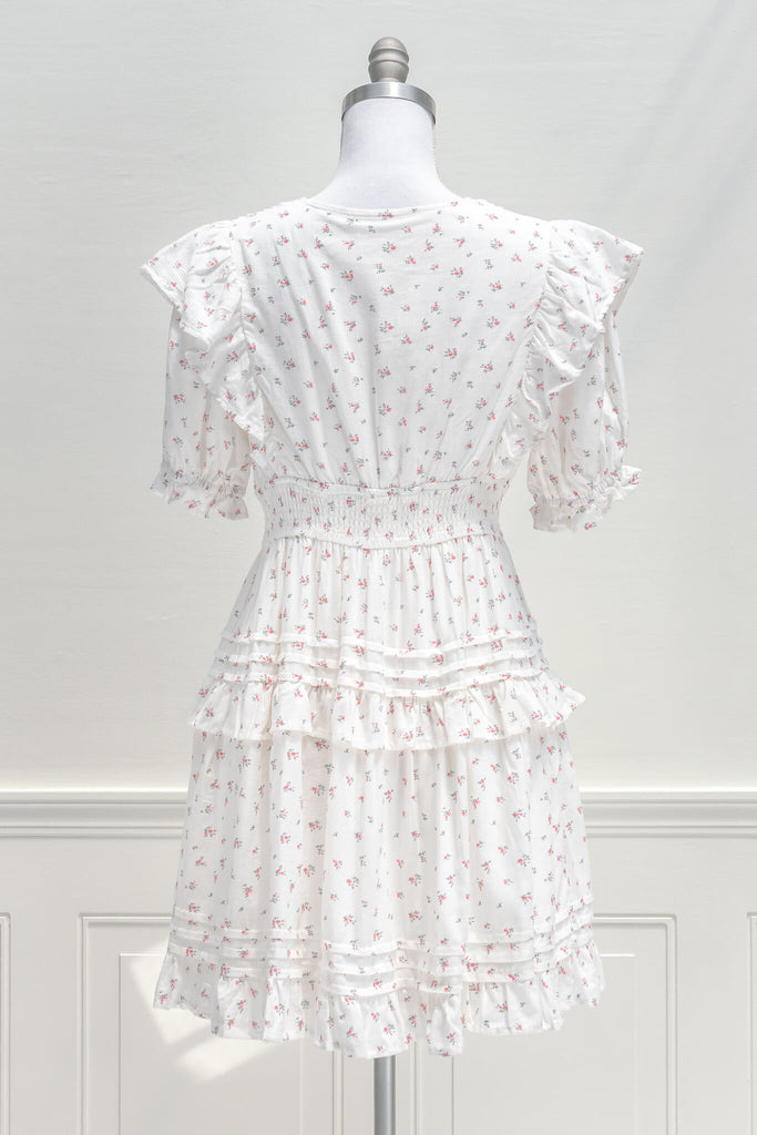 Parisian Parlour mini dress is the perfect addition to the dollette wardrobe. Featuring a lovely and delicate pink floral print on white cotton, short sleeves, a smocked elastic waistline, and pintuck-detailed skirt. aesthetic clothes - amantine - back view 