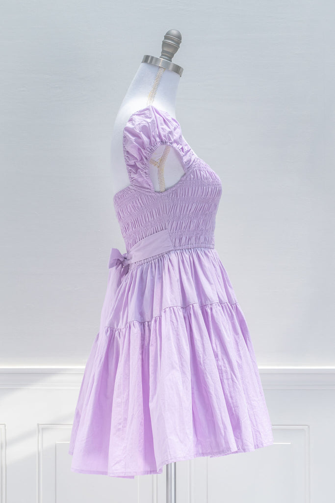 Sweet and feminine, the Lilac Meadows mini dress in lovely lavender cotton features a square neckline, short capped sleeves, fit-and-flare silhouette, and a smocked elastic bodice with side ties. side View