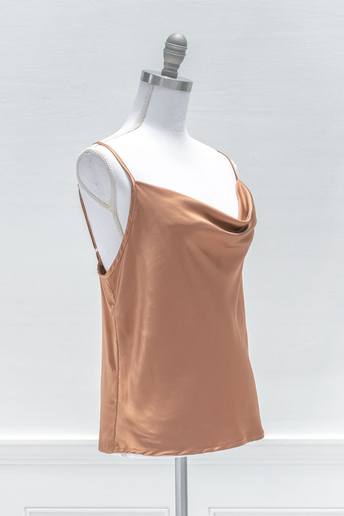 Chic and feminine, the Vivienne camisole in burnt sienna satin is a must-have for the French-aesthetic wardrobe. Featuring a relaxed fit, adjustable shoulder straps, and a flattering cowl-style neckline - aesthetic clothes - amantine - quarter view