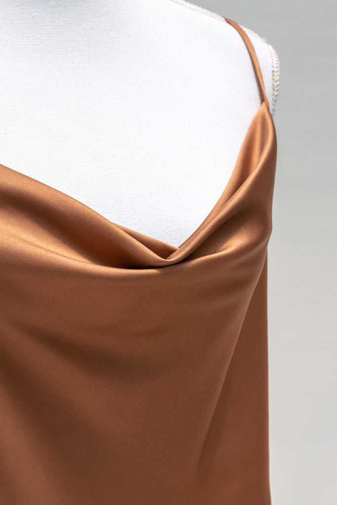 Chic and feminine, the Vivienne camisole in burnt sienna satin is a must-have for the French-aesthetic wardrobe. Featuring a relaxed fit, adjustable shoulder straps, and a flattering cowl-style neckline - aesthetic clothes - amantine - up close fabric view