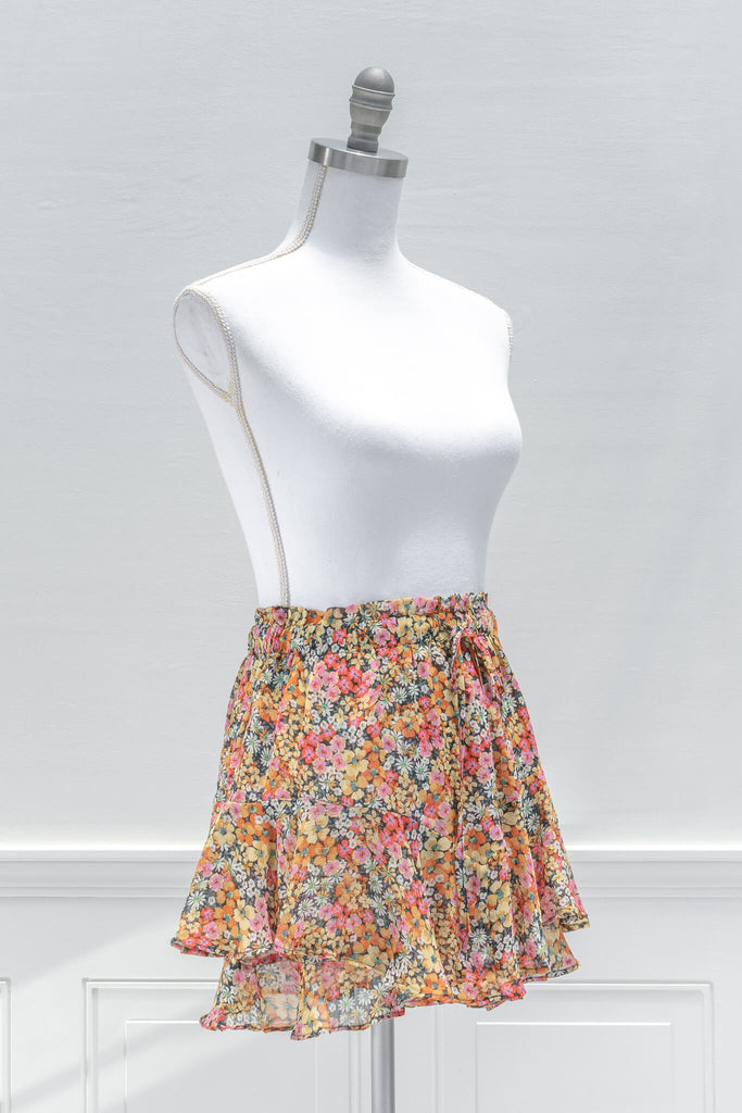 A feminine French inspired skirt:A pop of color for summertime, the fun and flirty BLANK mini skort features an elastic waistline, yellow and pink floral print chiffon, and a tiered outer skirt with a skort-style inner lining - aesthetic clothes - amantine - quarter view