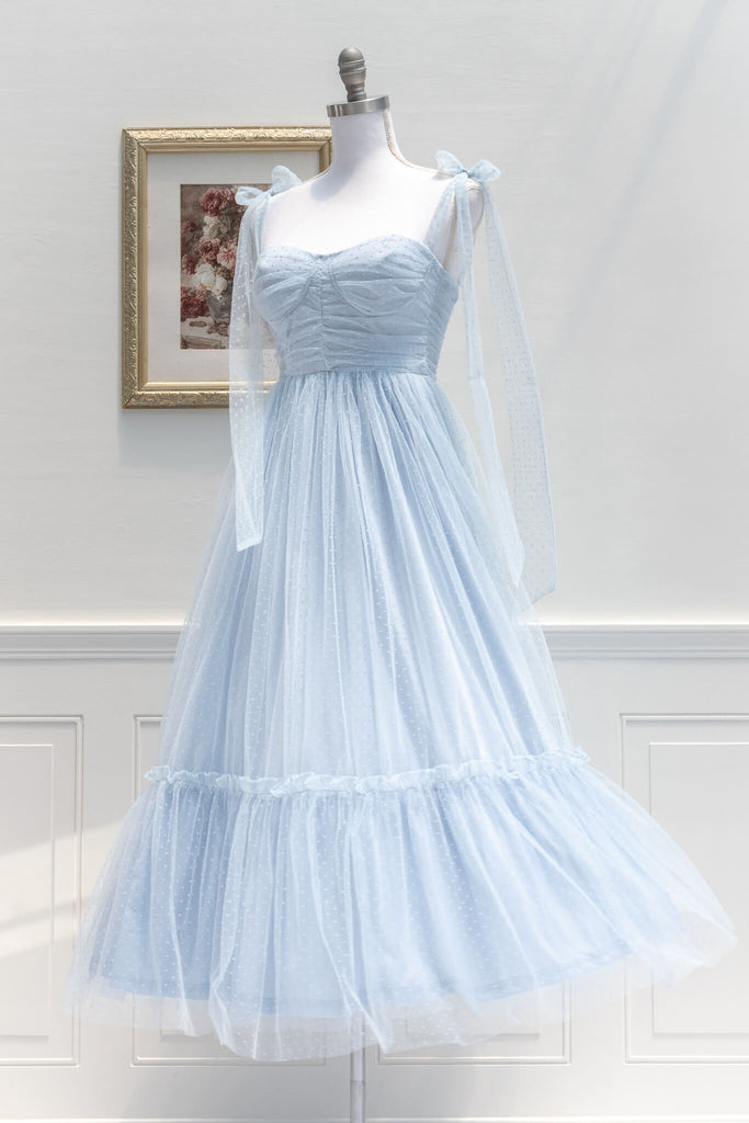 French Dress and Feminine aesthetic - a lovely dress in blue swiss dot tulle featuring dramatic tie-shoulder, center-back zipper, a ruched bustier-style sweetheart bodice. Amantine- quarter view