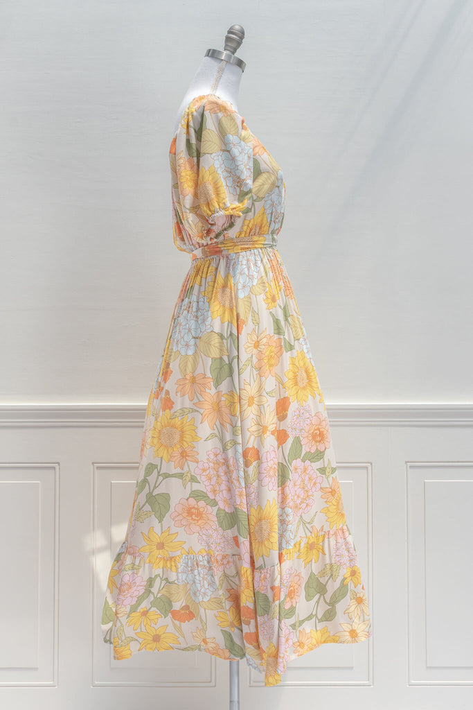 French Dresses - a Maxi in yellow and green florals features a faux-wrap v-neckline, a removable waist tie, shorts sleeves, and elastic waistline for a comfortable fit. Amantine clothing - side view 