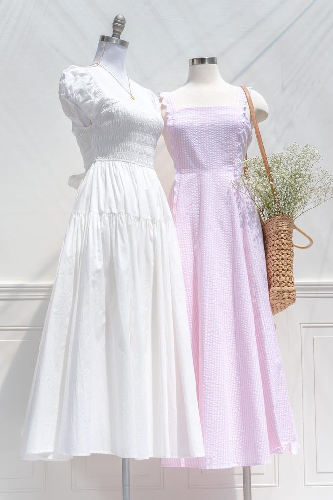 aesthetic clothes and dresses from amantine boutique - a beautiful long white dress with a square neckline and cap sleeves - full skirt - cotton dress - next to a pink dress view 