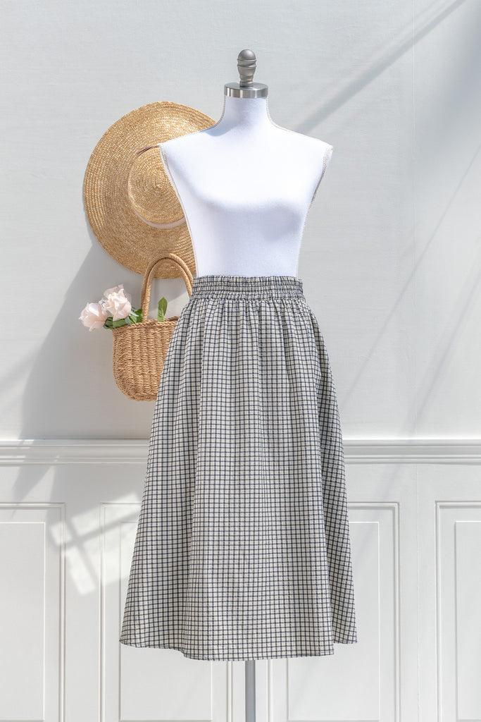 Amantine Arden plaid A-line midi skirt in navy check with elastic waistband and side pockets — front view