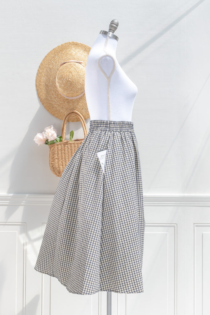Arden plaid midi skirt — side view with soft drape and pocket placement