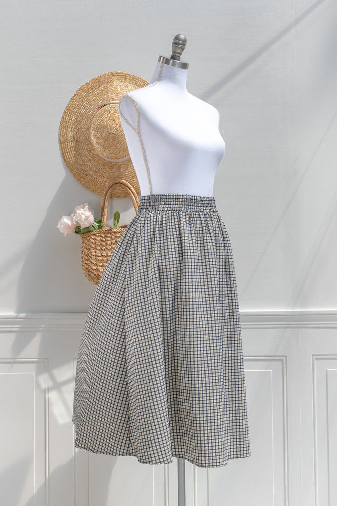 Arden navy check plaid midi skirt — three-quarter view showing gently flared A-line silhouette
