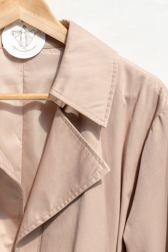 Smooth, structured outer fabric in sand — Charlotte trench coat texture close-up