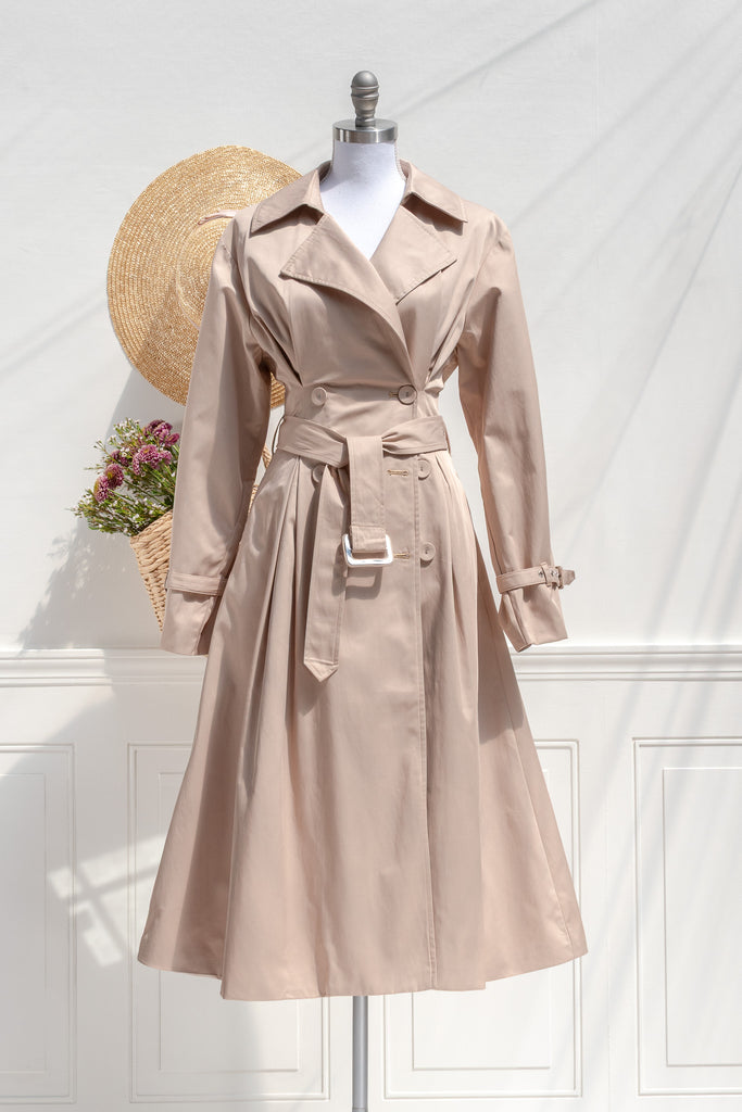 Amantine Charlotte fit-and-flare trench coat in sand with defined waist, removable belt, and pleated skirt — front view