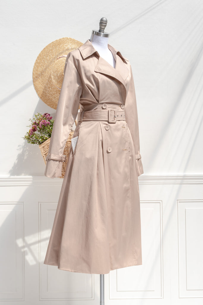 Charlotte sand trench coat — three-quarter view showing princess seams, wide lapels, and cinched belt