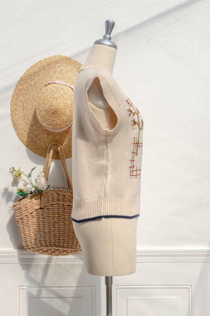 Homestead house-motif sweater vest—side view with relaxed armhole and cropped hem