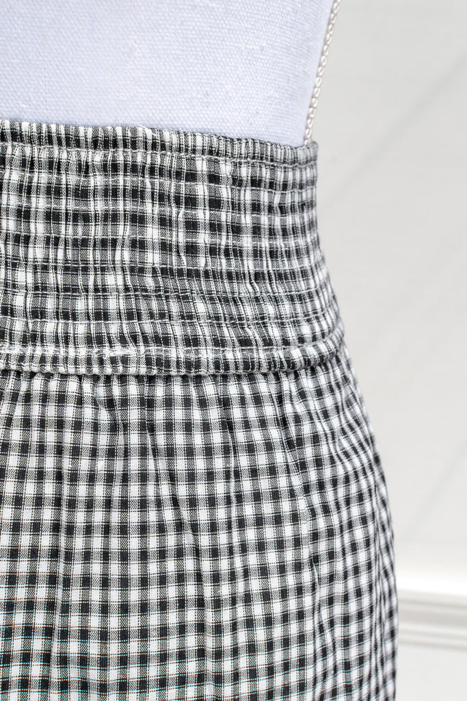 Close-up of elasticized waistband on the Layla gingham midi skirt